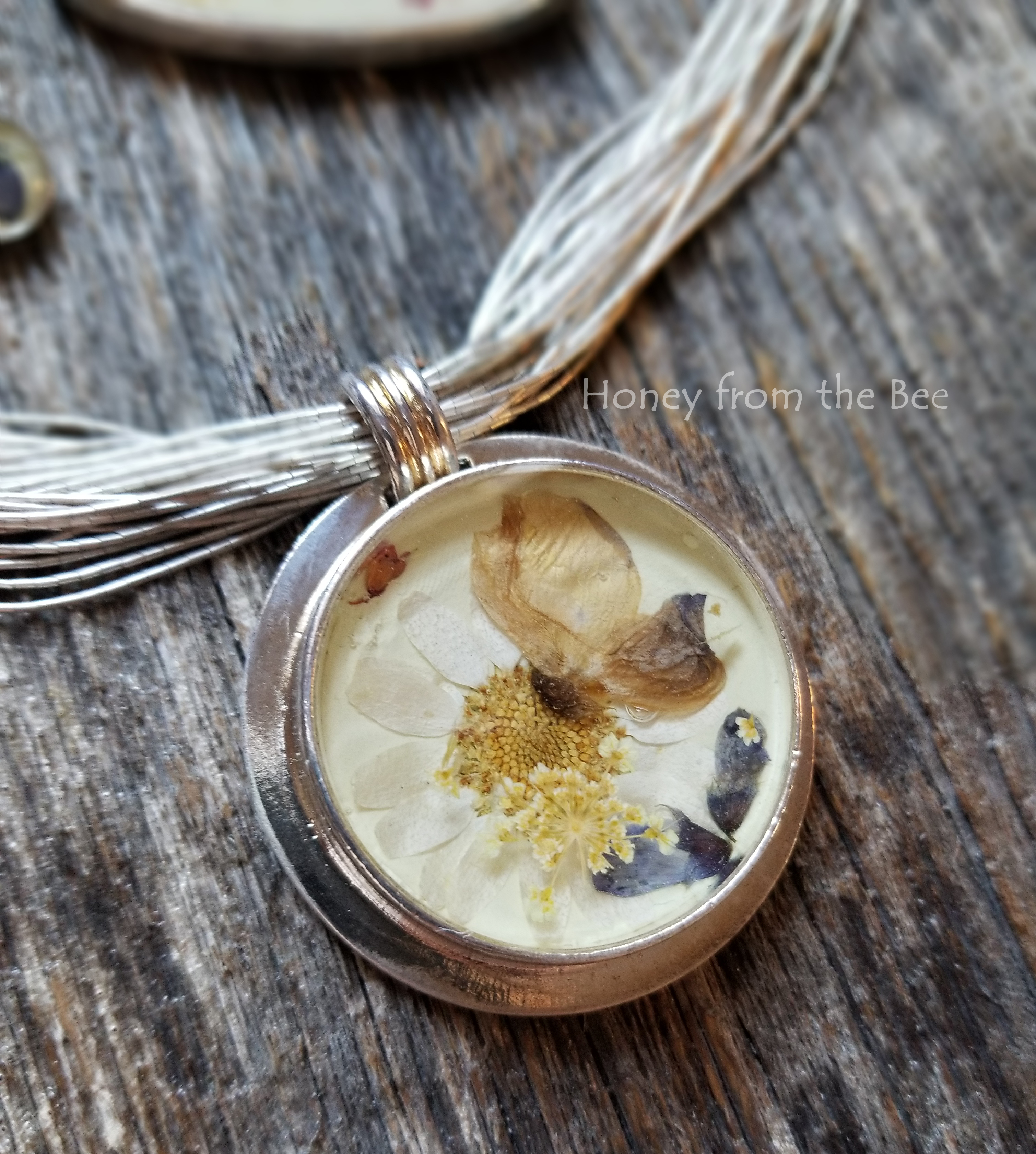 Dried flowers in resin focal with liquid silver necklace