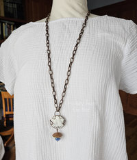 Tunic length pendant with nature motifs on model
