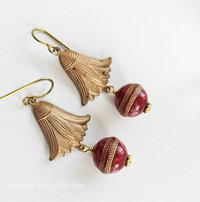 Red and gold colored earrings feature vintage components