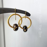 Animal print earrings feature giraffe print lampwork and gold hoops