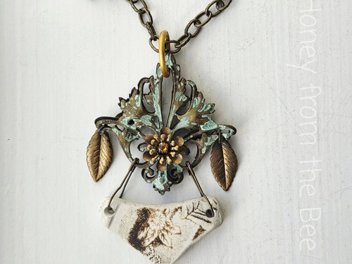 Mixed Media art necklace features sea pottery, brass filigree and crystal