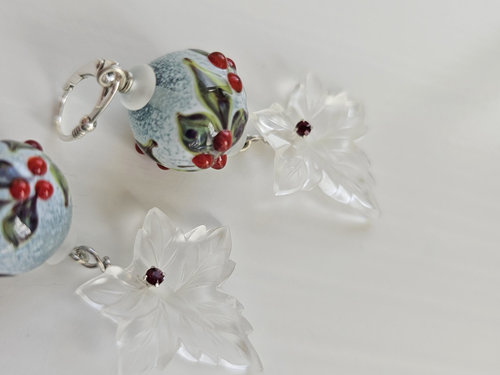 Winter season earrings feature holly lampwork and frosty glass leaves