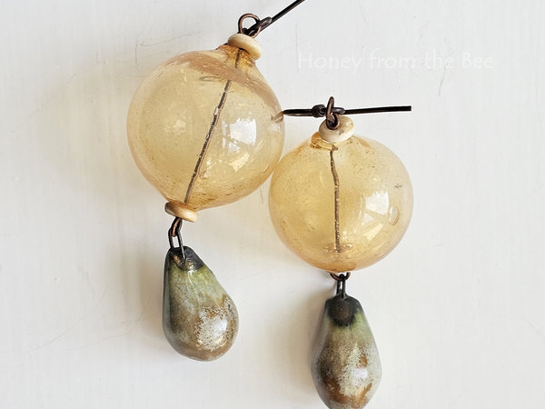 Yellow earrings feature hollow lampwork and ceramic drops