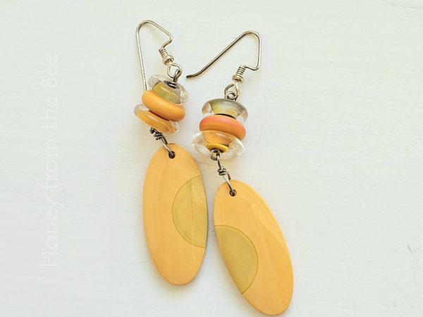Orange artisan earrings feature lampwork and billiard ball slices