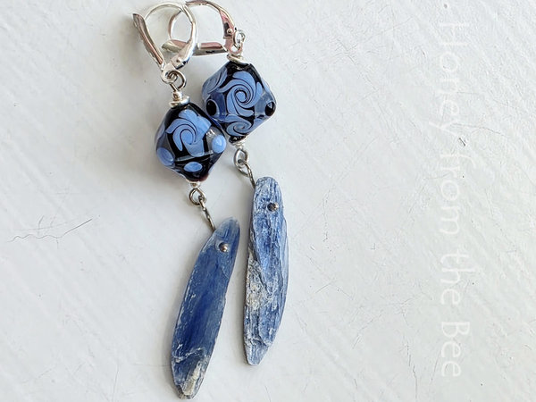 Blue kyanite earrings feature lampwork in lavender and purple