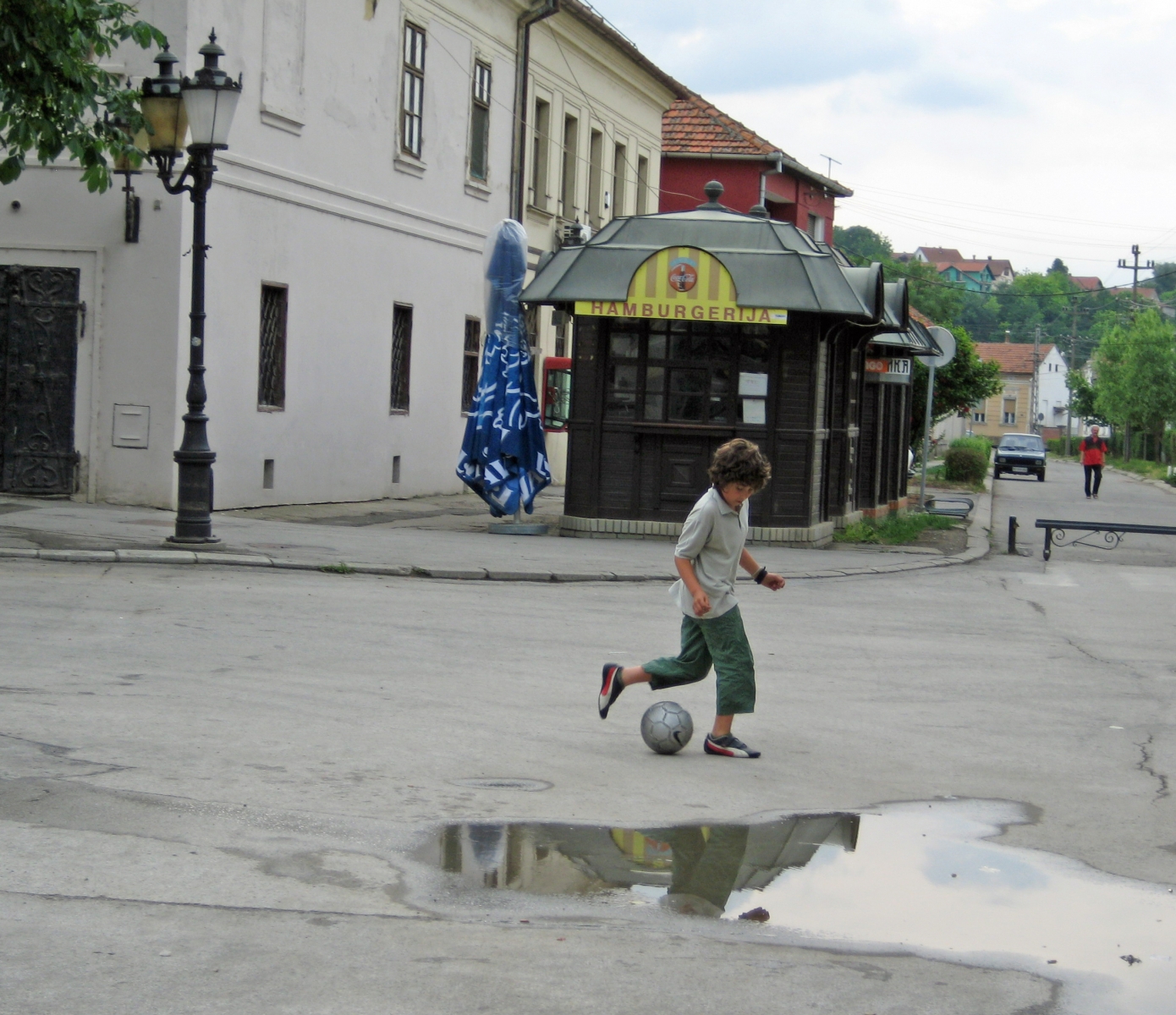 Boy playing football on streets in Serbia