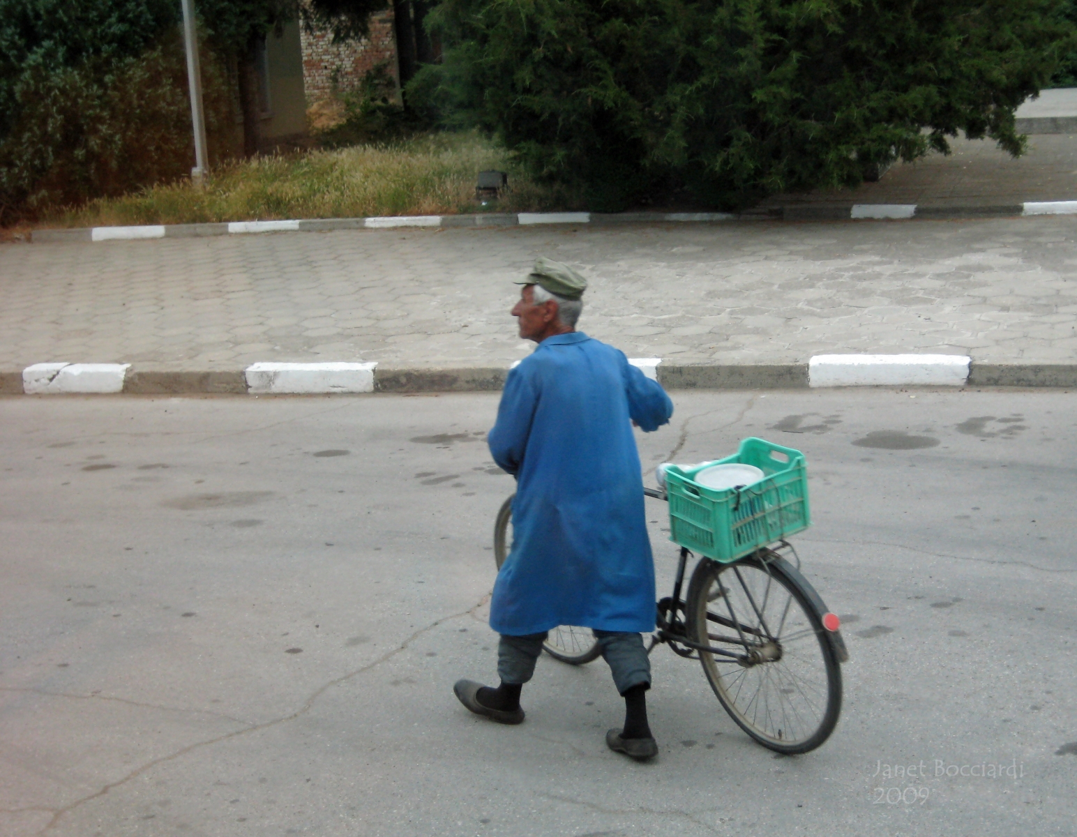 Man in blue coat with bike