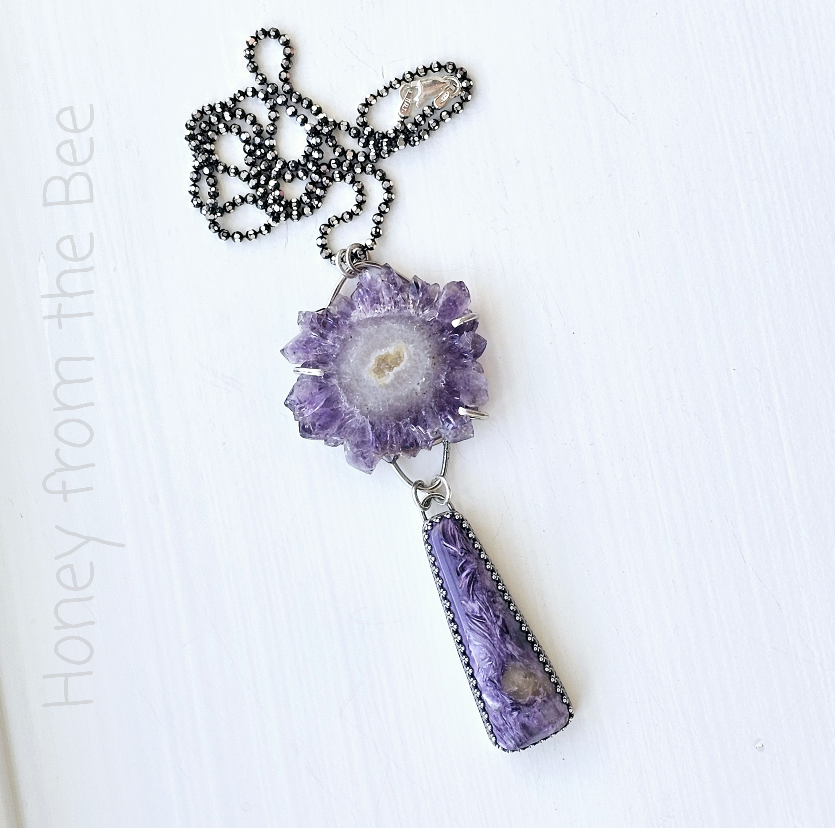 Artisan pendant featuring Charoite and amethyst slice