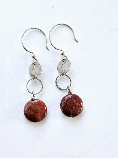 Circular Argument earrings features fossilized coral agate