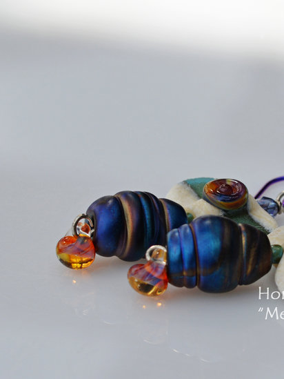 Metamorphosis earrings features lampwork