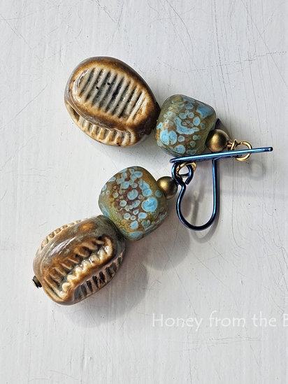 On the Surface earrings features lampwork and ceramic beads