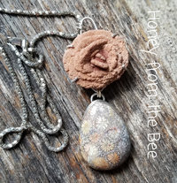 Orange and grey necklace comprised of fossilized coral agate, byrite rose, and sterling silver.