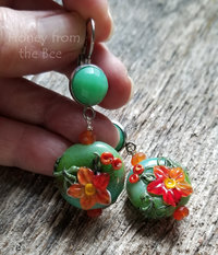 Green and orange artisan earrings