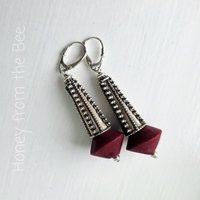 Sterling silver earrings with dark red bead
