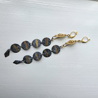 Shoulder duster length earrings in gold and green