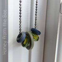 Artisan necklace features blue and green lampwork in matte and shiny finishes