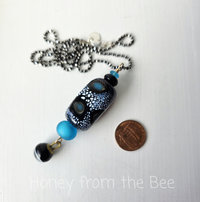 One of a kind artisan pendant features fabulous lampwork in blue and black
