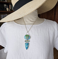 Stunning art pendant on model.