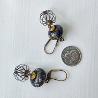 Boho style earrings feature raku lampwork with steel and brass
