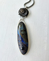 Mixed Media pendant features ceramic and ammonite set in sterling silver