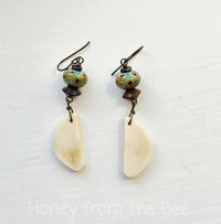 Artisan earrings feature lampwork beads in teal and brown