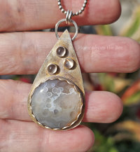 Botswana Agate and moonstone pendant set in a sterling silver teardrop