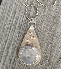 Silver and taupe pendant features botswana agate and moonstones