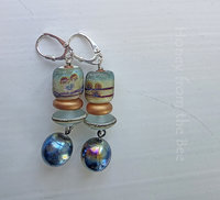 Teal and copper earrings feature lampwork