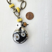 Floral necklace in black, yellow and white