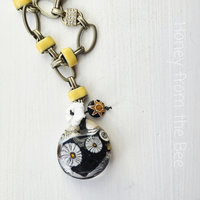 Statement necklace in black and yellow with daisy motif