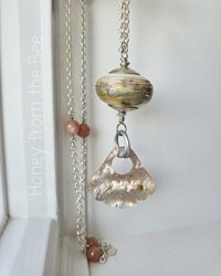 Iridescent lampwork focal necklace with peach moonstone and sterling silver