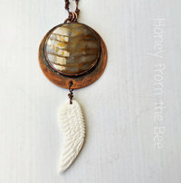 Angel wing pendant with copper and petrified wood focal