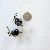 Floral earrings feature daisy lampwork and vintage glass drop