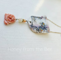 Feminine necklace with ceramic focal and coral rose