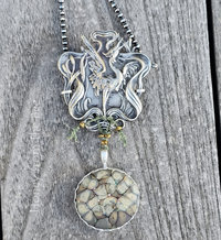 Crane pendant with green art glass cabochon