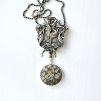 Art Nouveau style pendant with crane image and art glass dangle