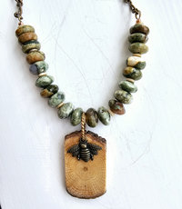 Faceted green and brown gemstone necklace with wood and brass bee