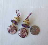 Artisan earrings feature lampwork in cream and red and purple