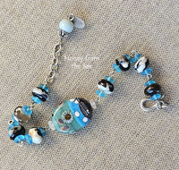 Celadon and aqua lampwork bead by Lori Lochner is the focal in this one of a kind artisan bracelet.
