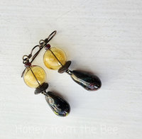 Hollow glass earrings with ceramic drops