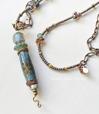 Lampwork necklace in shades of aqua, sage green, and amber