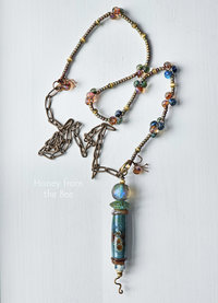 Long art necklace features stunning lampwork