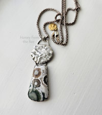 Gorgeous green, white and brown ocean jasper cabochon with reticulated sterling silver disc pendant necklace