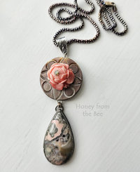 Stony Creek Jasper in peach and grey hangs below antique mother of pearl button with lotus flower center pendant necklace