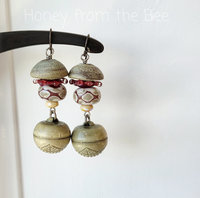 Mushroom earrings feature lampwork in rose and cream