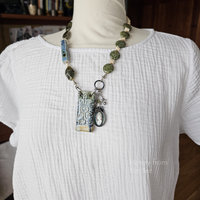 Blue and Green necklace with garnet, ceramic and vintage cameo on model