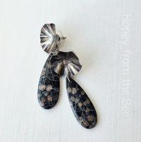 Flower earrings feature sterling silver and black gemstone