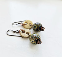 Boho style earrings feature antique bone buttons and raku frit lampwork
