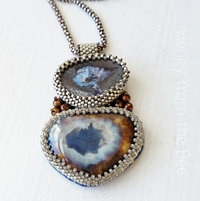 Boulder Opal pendant is bead embroidered with ceramic focal