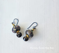 Antique button earrings with lampwork in black, yellow, purple